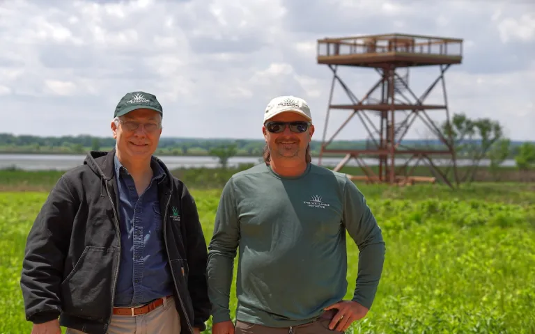 Paul Botts, executive director of The Wetlands Initiative, and Justin Seibert, the Dixon Refuge site manager, stand in front of the refuge’s observation tower. Photo by Ethan Freedman.