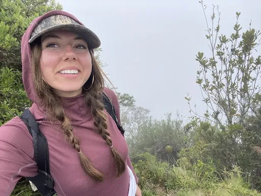 a person taking a selfie in a lush green area outdoors