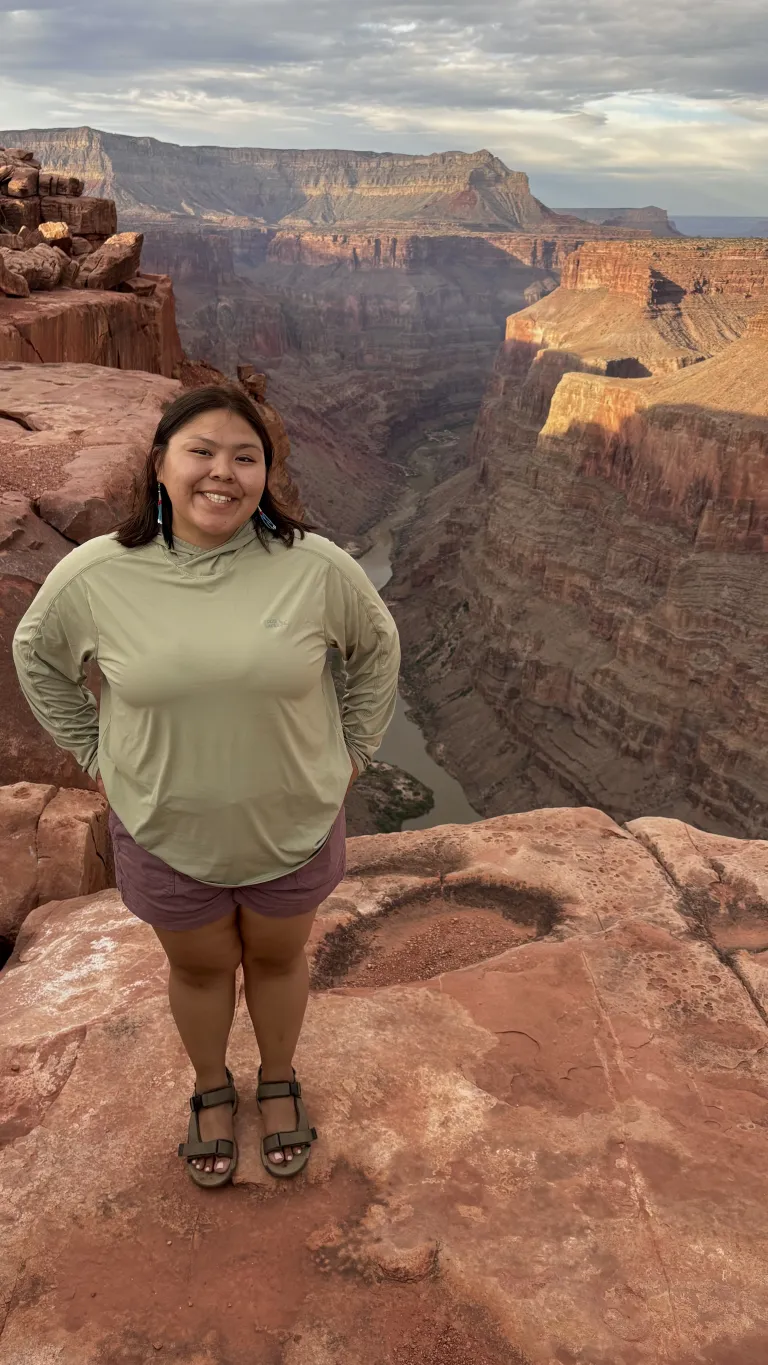 A person standing on the edge of a canyon
