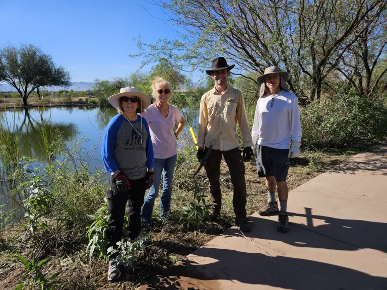 a group poses for a photo next to a river
