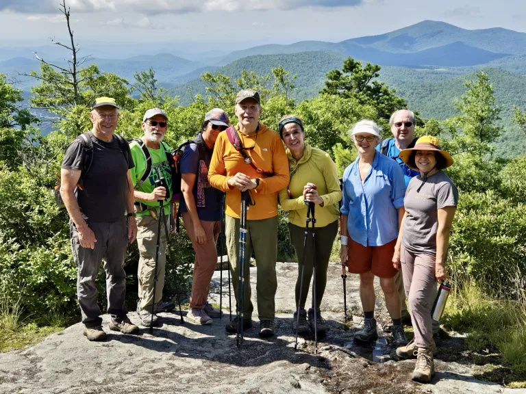 Hikers stand at an overlook
