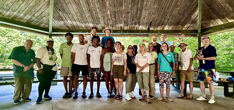 A group of people gather at a pavilion for a photo at Metro Atlanta Group's recent picnic.
