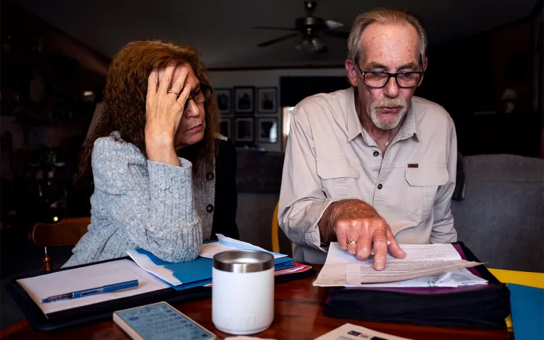 Elizabeth and Leo DeMi review a water contamination notice sent by the Brookside Village mobile home park administration at their kitchen table in Berwick, Pa. on Aug. 27, 2026.