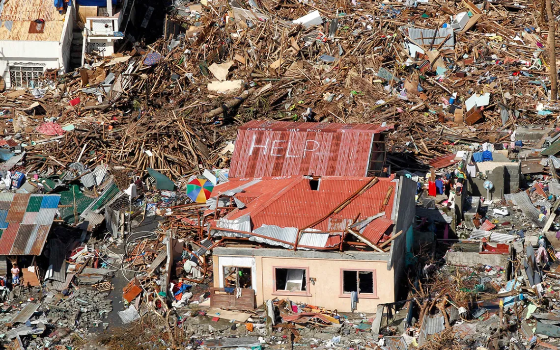 A sign for help is seen amid the destruction left from Typhoon Haiyan in the coastal town of Tanawan, central Philippines