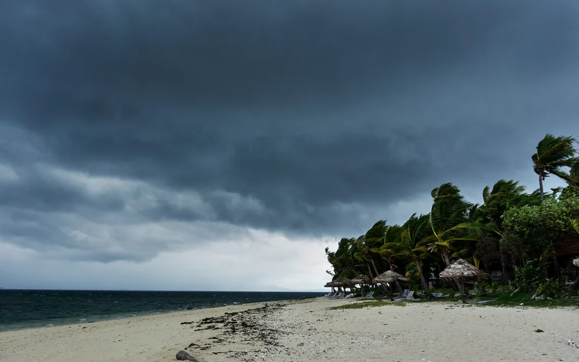 Dark clouds building over a tropical island indicate rain on the way.