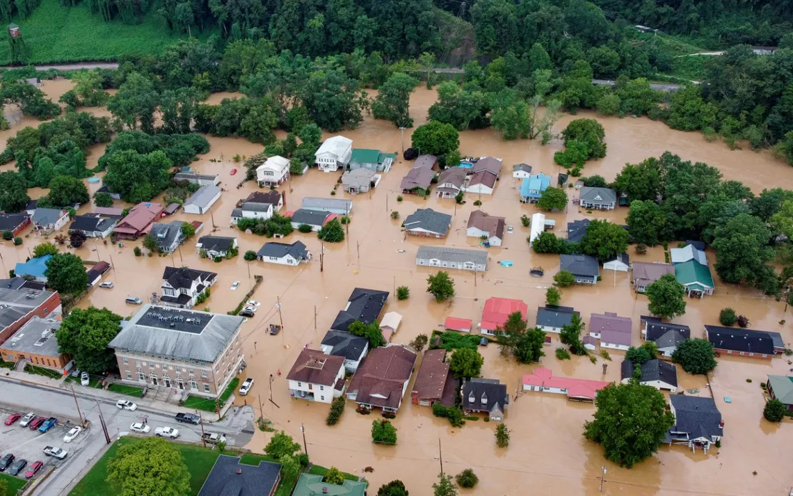 Aerial view shows the roofs of homes and buildings submerged in brown floodwaters in Jackson, Kentucky.