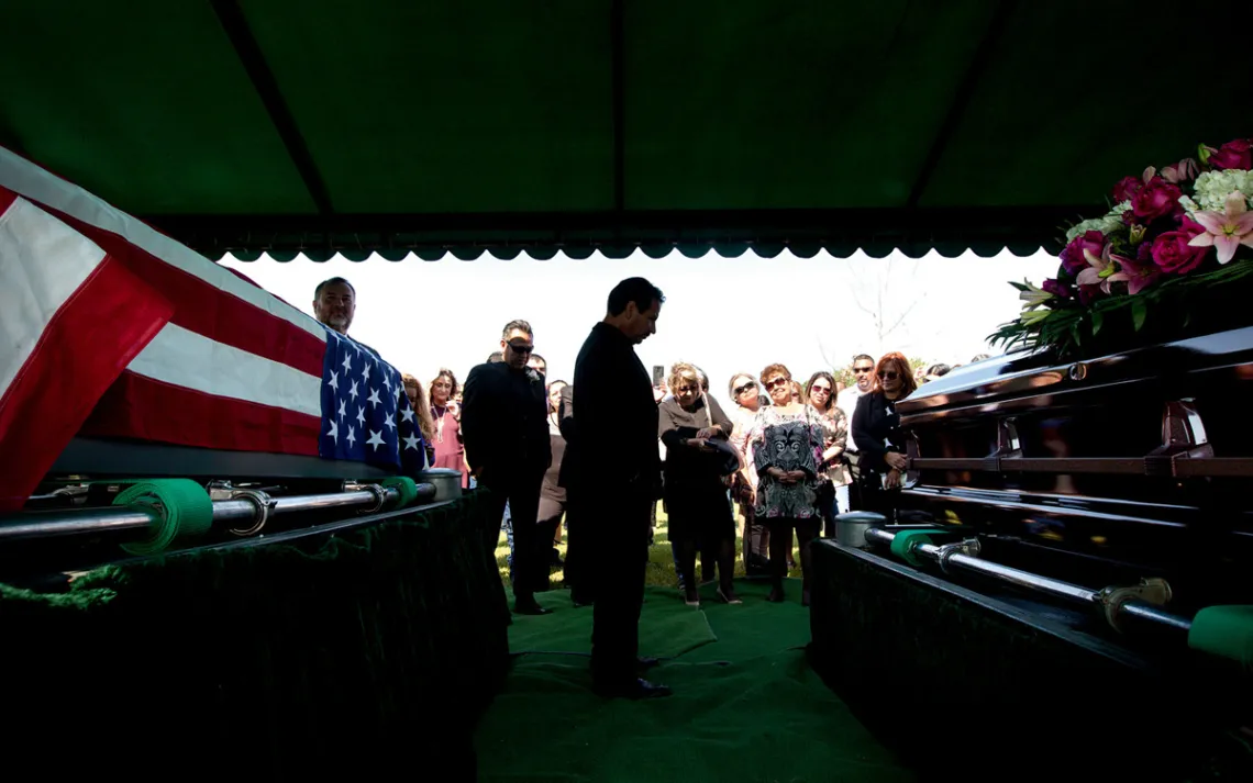 Ric Saldivar, center, at the funeral for his parents. The pair drowned along with four great-grandchildren. 