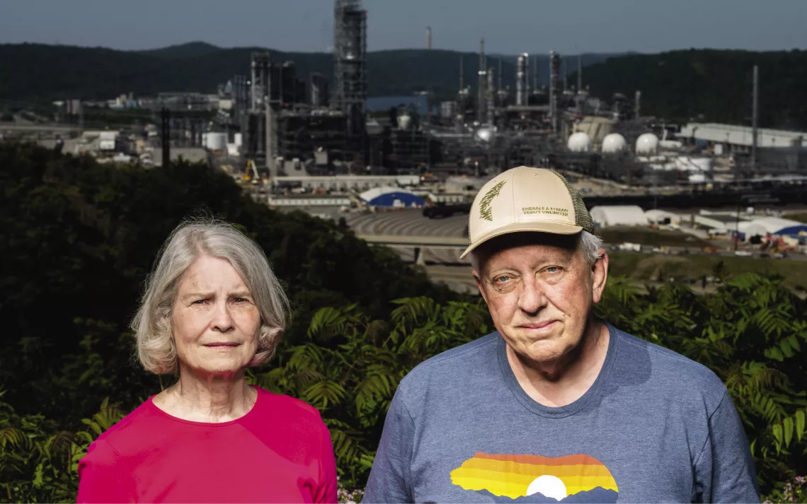 Terrie Baumgardner and Bob Schmetzer face the camera in front of the Shell cracker facility.