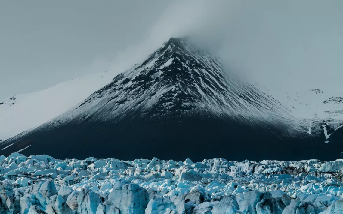 Close-up of Vatnajökull, with mist covering its top and chunky ice at its base.