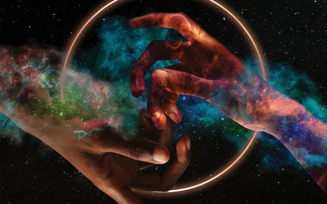 Photo illustration shows two hands coming together in front of a solar eclipse and a galaxy.