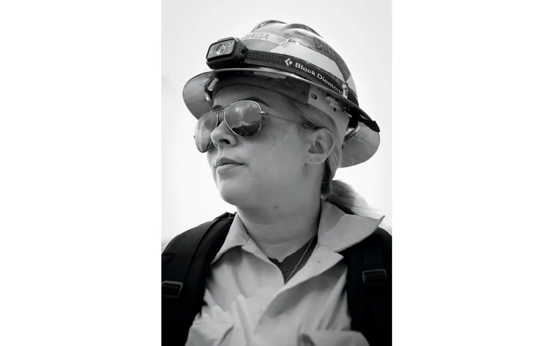 Amanda Burciaga wears a hard hat and sunglasses and looks off to the side.