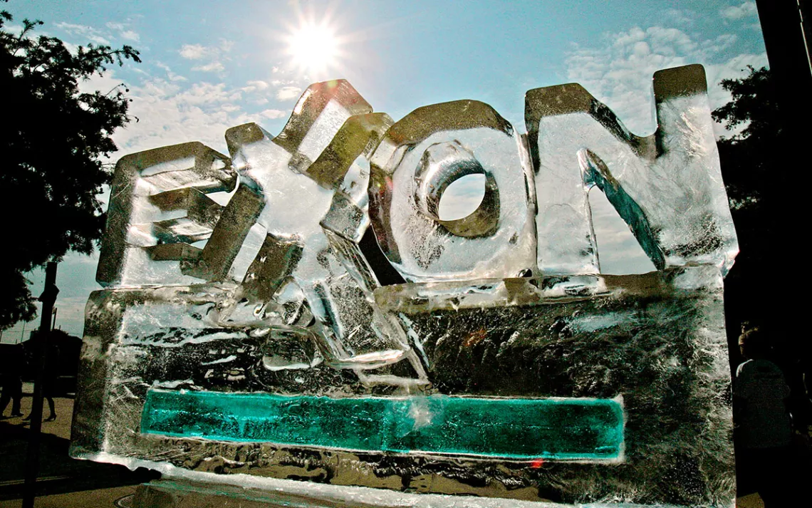 Ice sculpture in the shape of the Exxon logo against a bright blue sky.