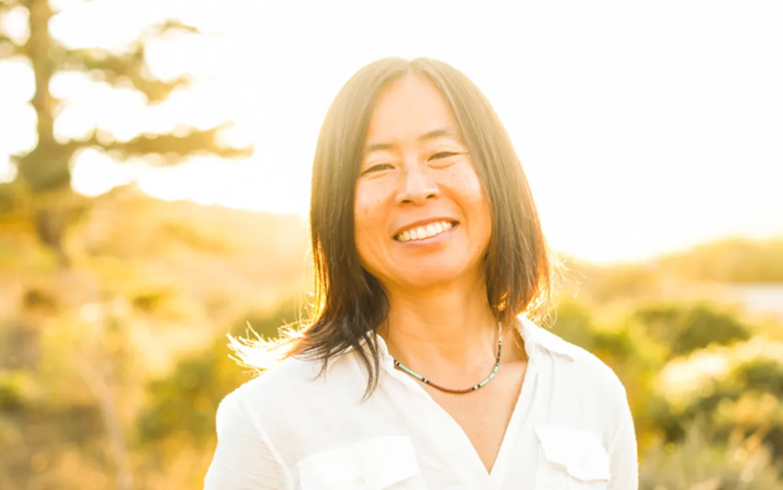 Image of Miho Aida in a sunlit landscape. 