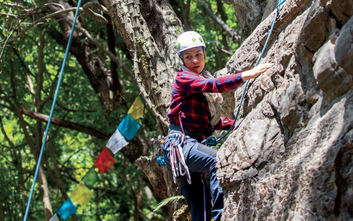 Nineteen-year-old Mariam rock climbs in the Nagarjun Forest Reserve outside Kathmandu. 
