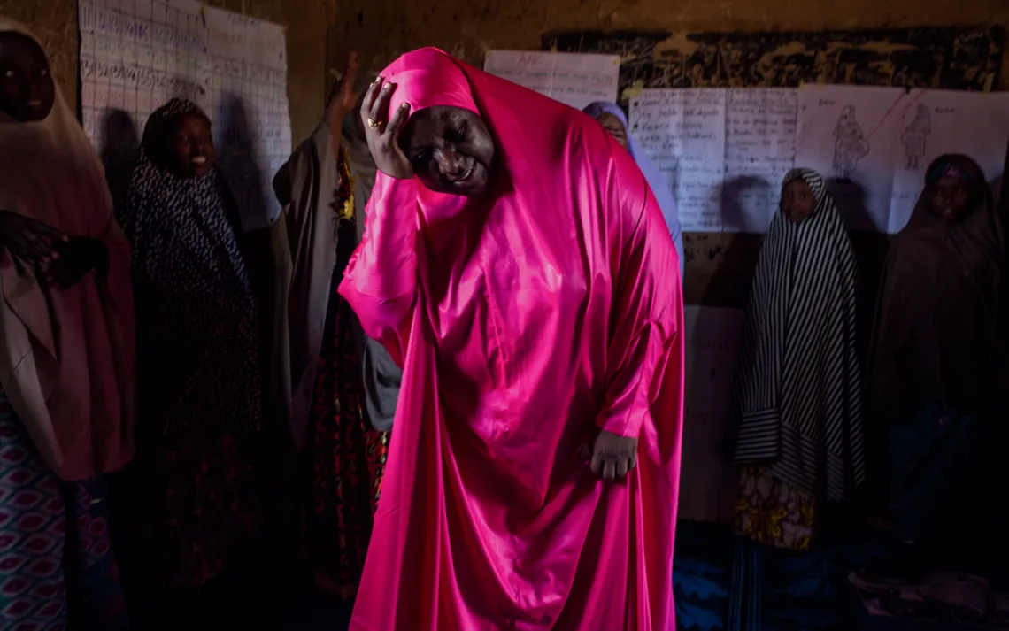 Center for Girls' Education director Habiba Mohammed acts out labor pains during a review of reproductive health.