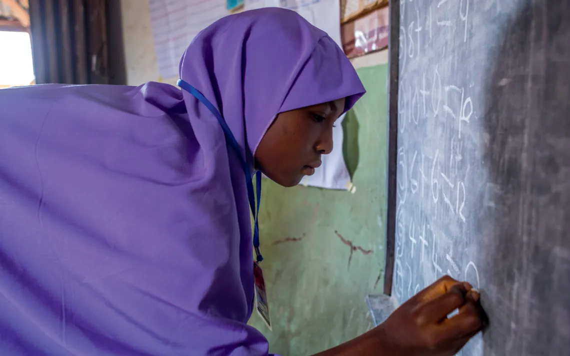 A teen practices her numbers
