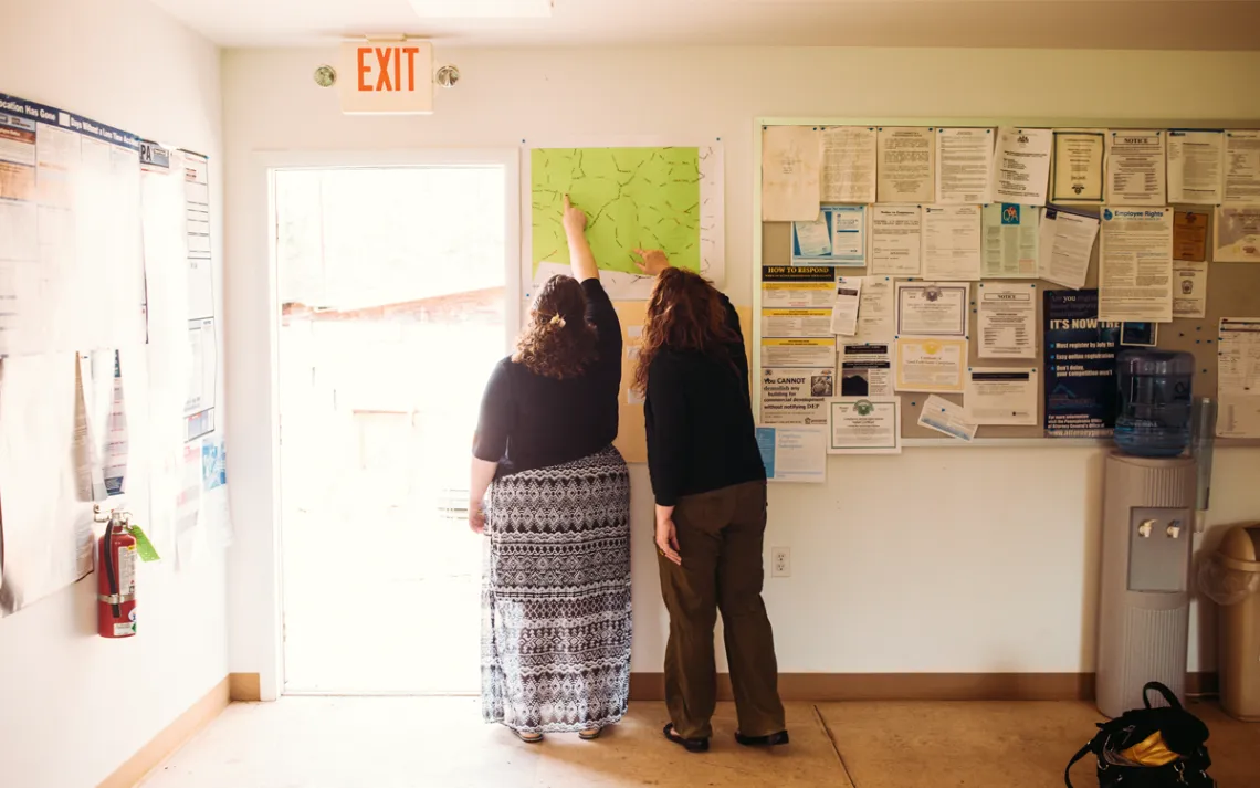 Amy Aikens, the town secretary, and Stacy Long talk at the Township Municipal building in Grant Township.