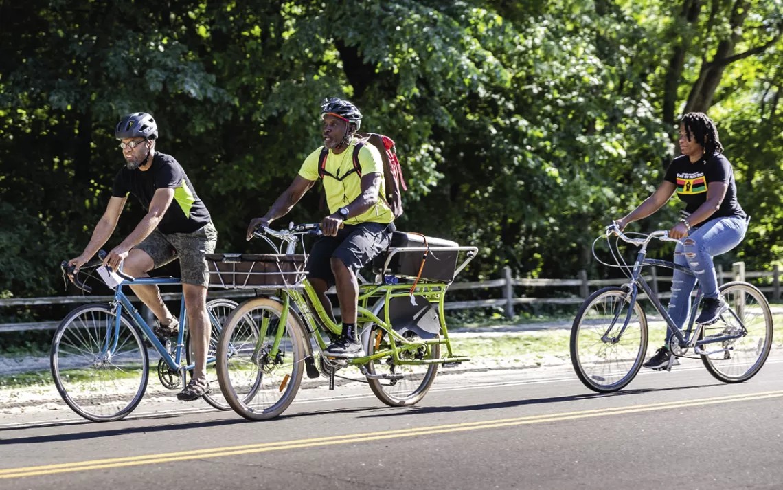 Anthony Taylor (center) rides through Theodore Wirth Regional Park with a group of cyclists on the Juneteenth Blackout ride.