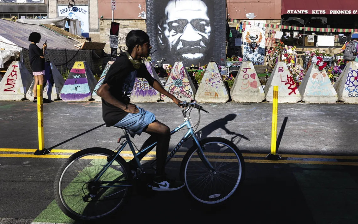 Ernest Bowie rides past George Floyd Square