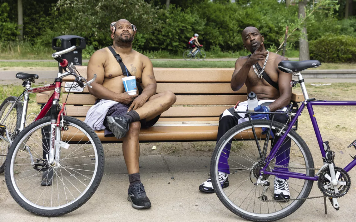 Tyrone Dixon (right) and a friend rest on West Bde Maka Ska Parkway