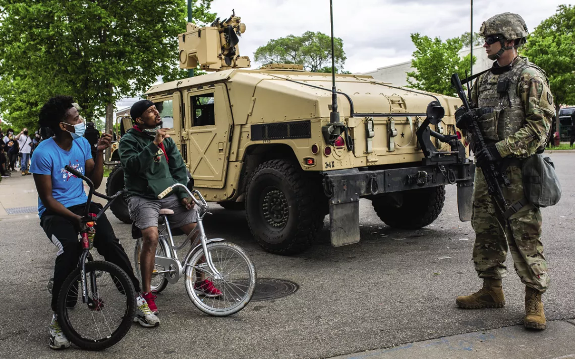 A member of the National Guard patrols the street as protesters demand justice for George Floyd.