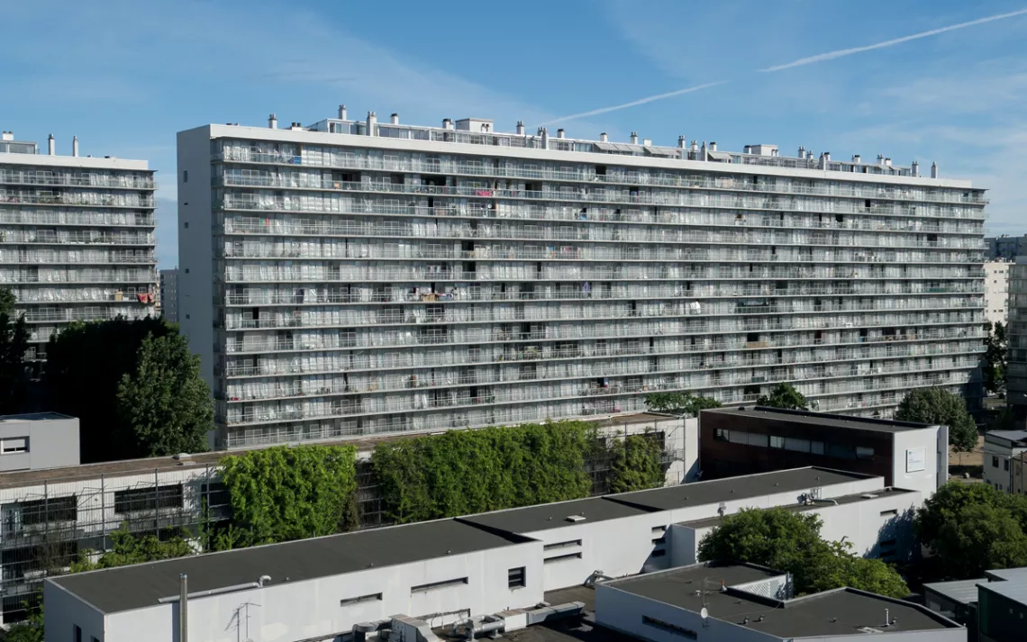 The complex was built in the 1960s and later remodeled by Anne Lacaton and Jean-Philippe Vassal, saving the buildings from demolition (shown here after adaptive reuse). 