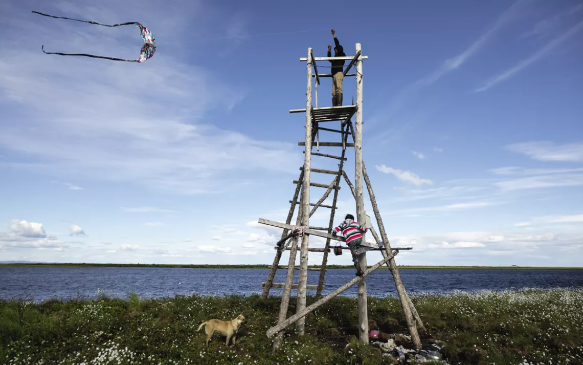 Kids play on a lookout tower at the camp.