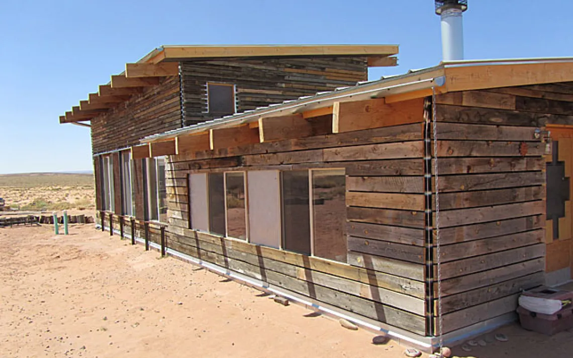 Twenty-three people built this 1,000-square-foot home and studio for an artist and her family. The siding is recycled barn wood. 