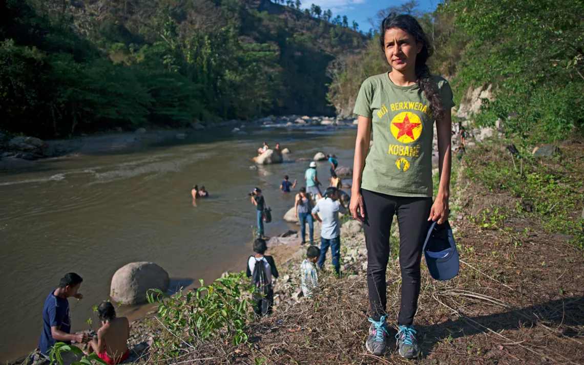 Bertha Cáceres Zúñiga (daughter of Berta Cáceres) stands next to the Gualcarque River, which her mother died protecting.