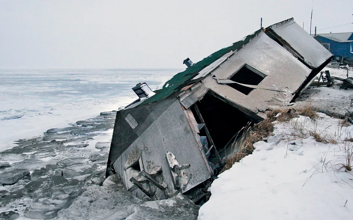 Nathan Weyiouanna's house slid onto the beach during a 2005 storm in Shishmaref, Alaska