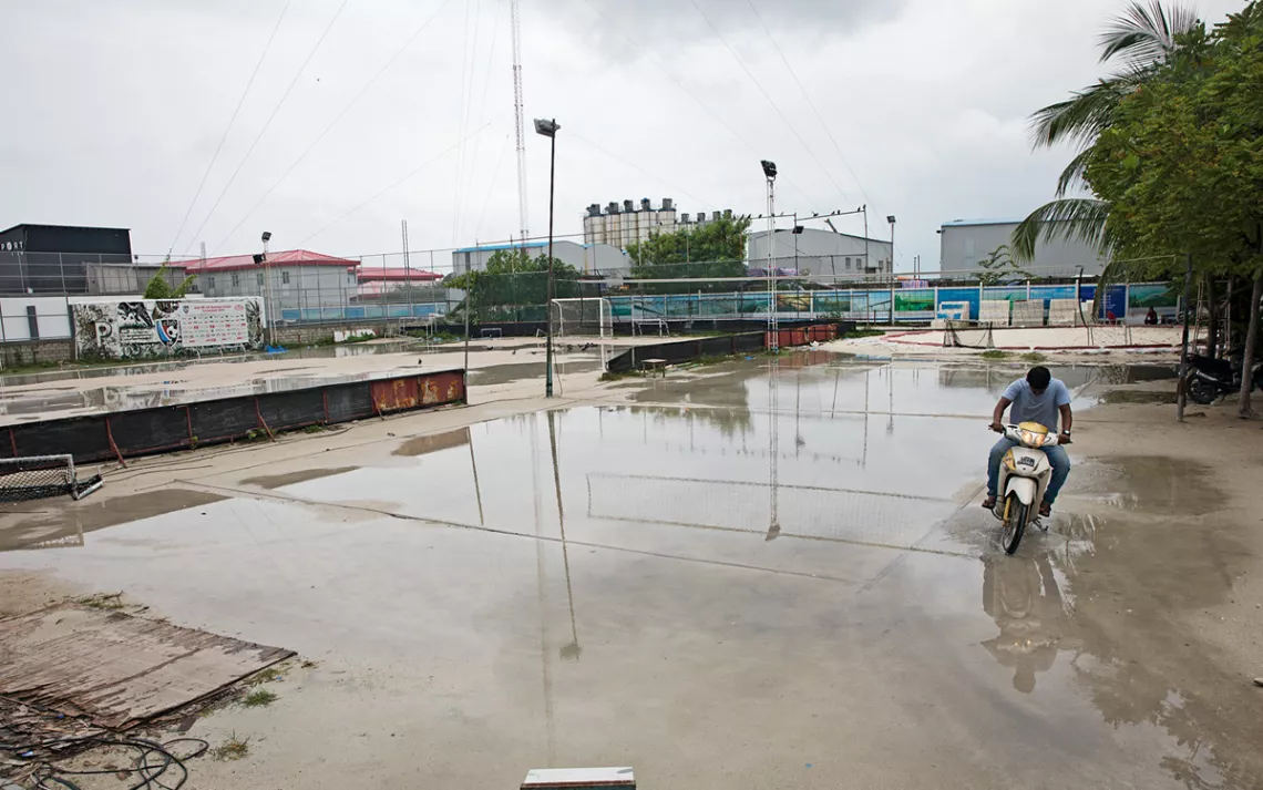 A shortcut across a flooded soccer field in Malé, the densely populated capital of the Maldives.