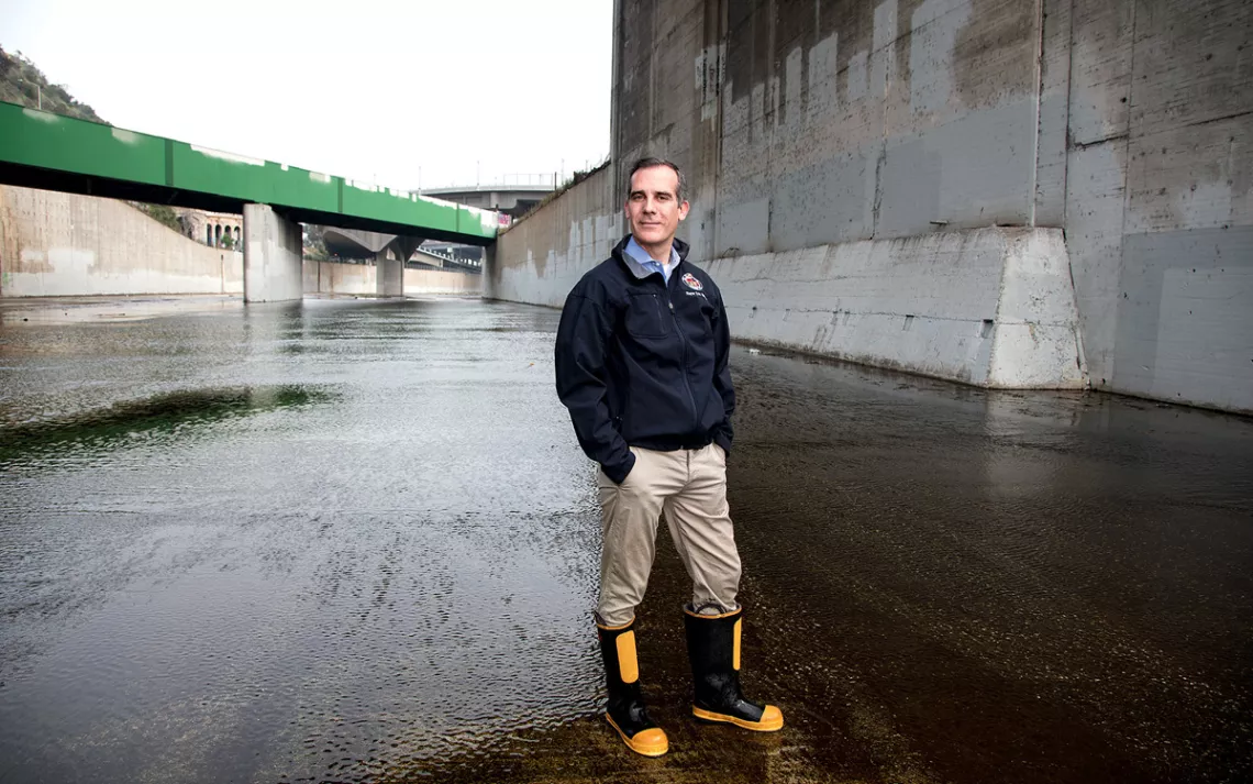 Mayor Eric Garcetti standing in the middle of the L.A. River on the west side of San Fernando Boulevard.