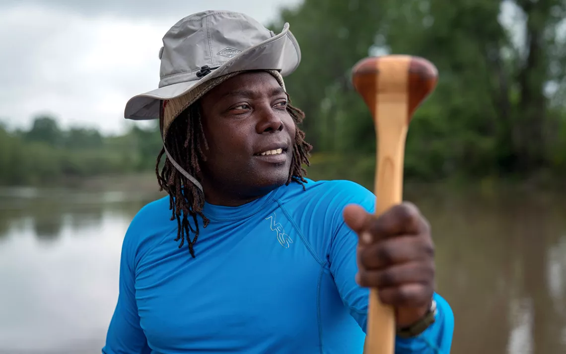 Lead guide Mark “River” Peoples holds up his paddle.