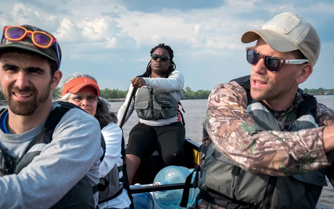Guide Valencia Metcalf leads three other paddlers downstream on the Mississippi.