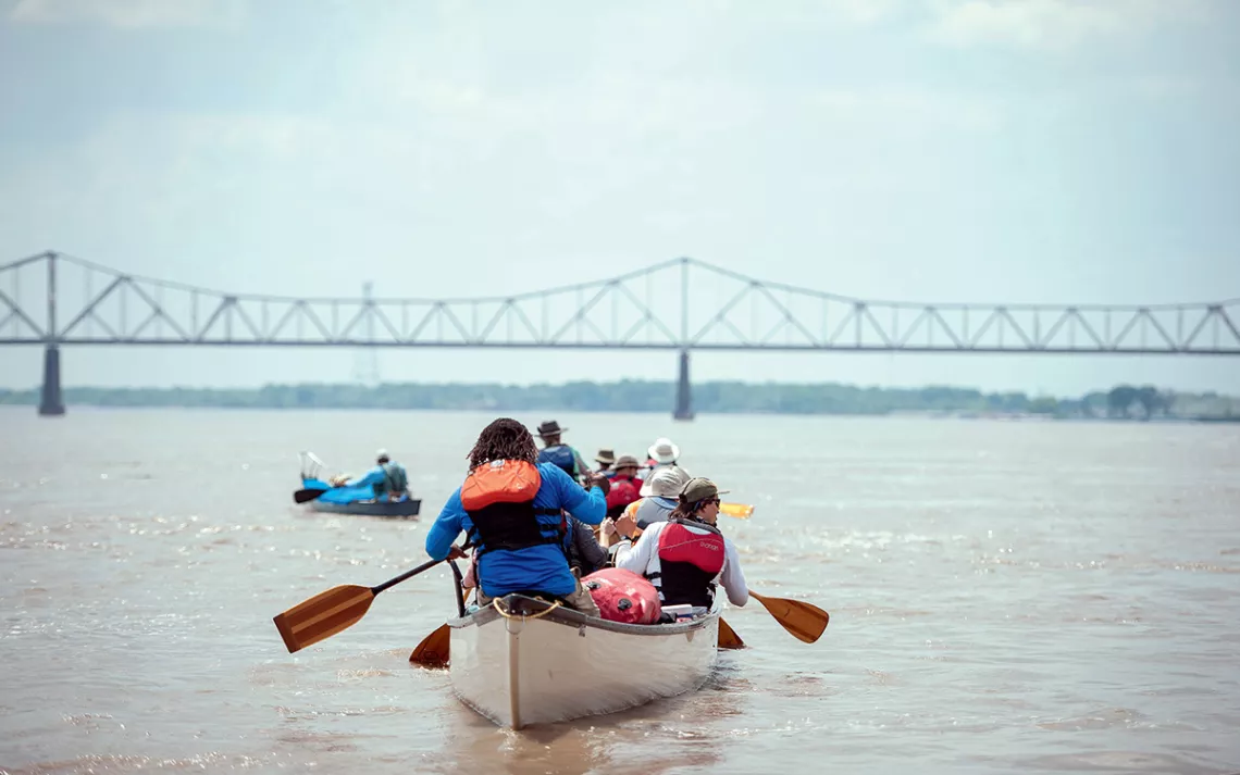 Canoers are about to paddle under the bridge in Helena, Arkansas.