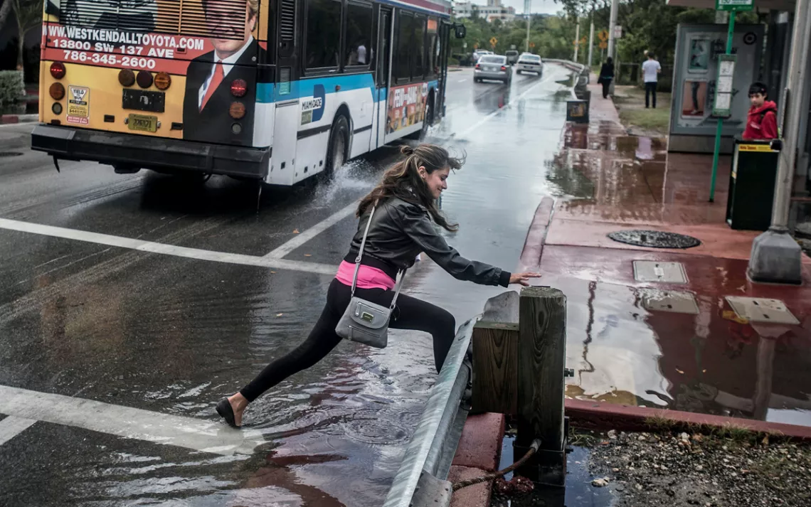 During a king tide in Miami Beach, water fills the streets, flowing over a poorly maintained seawall and up through the drainage system.