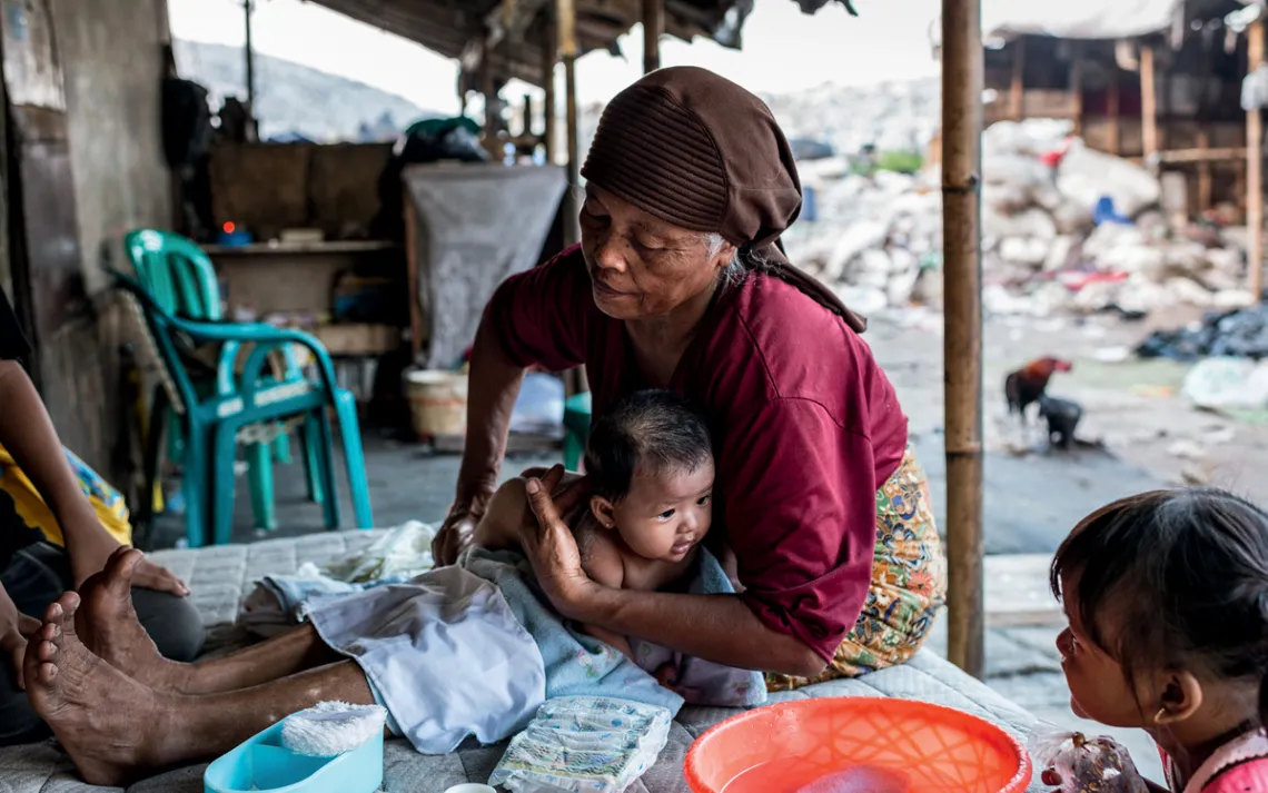 Muji helps take care of newborns, including washing them and monitoring their growth to determine if they need supplemental formula.