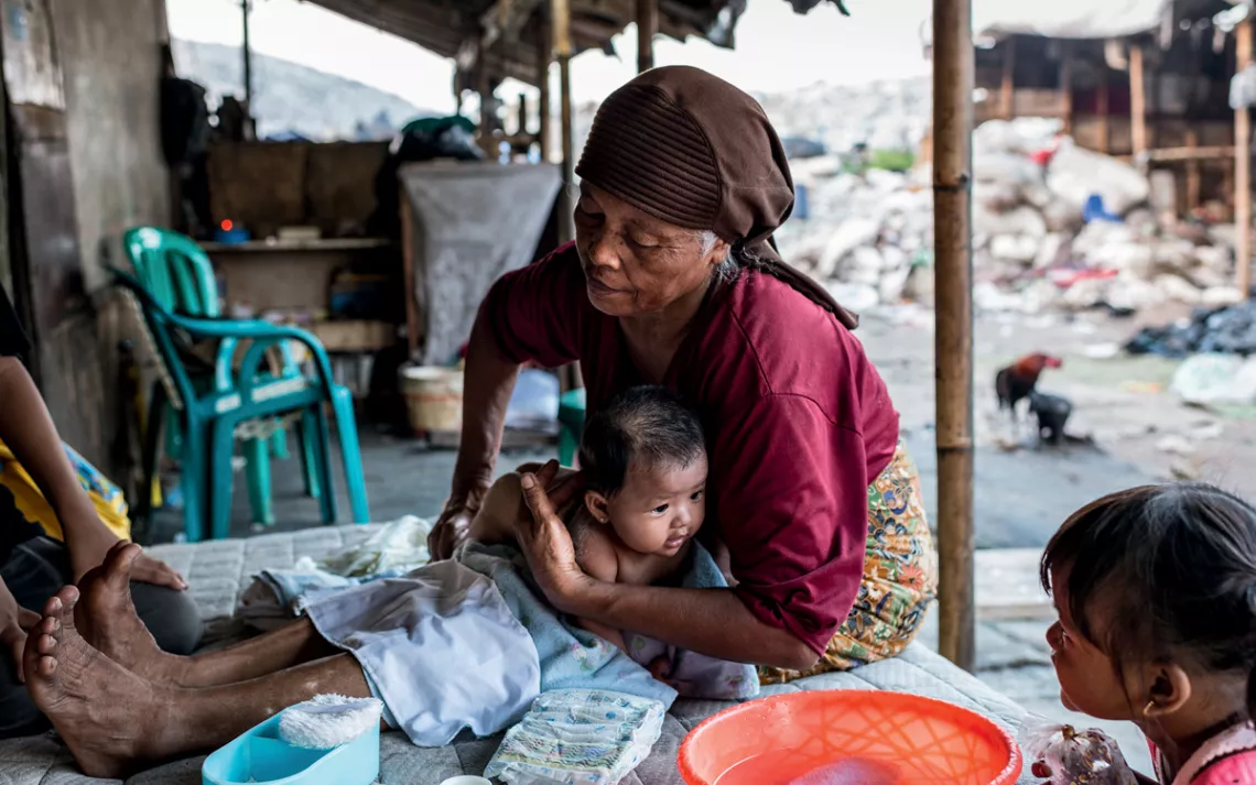 Muji helps take care of newborns, including washing them and monitoring their growth to determine if they need supplemental formula.