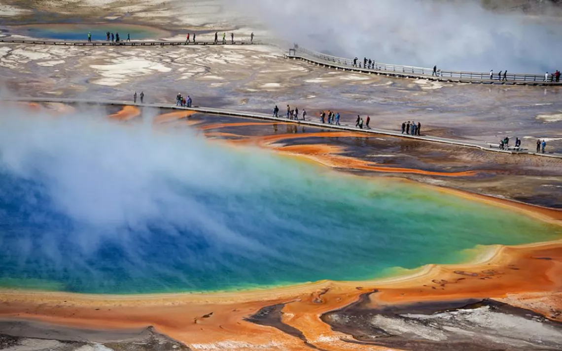 Summer visitors to Yellowstone National Park's Grand Prismatic Spring.