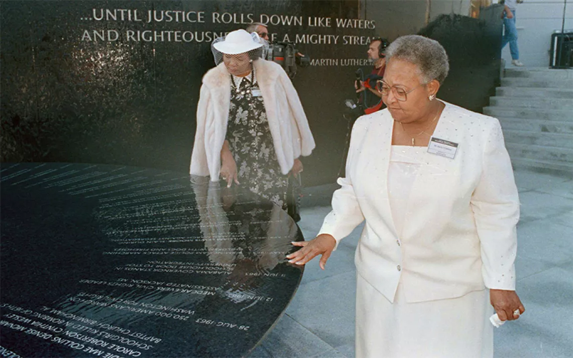 Mamie Till-Mobley, mother of lynching victim Emmett Till, right, and Wilma Allen of New Orleans search for their relatives' names on the black granite table at the Civil Rights Memorial in Montgomery, Ala., Nov. 5, 1989.