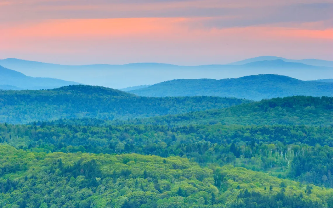 Tree covered Vermont Mountains at Sunrise.