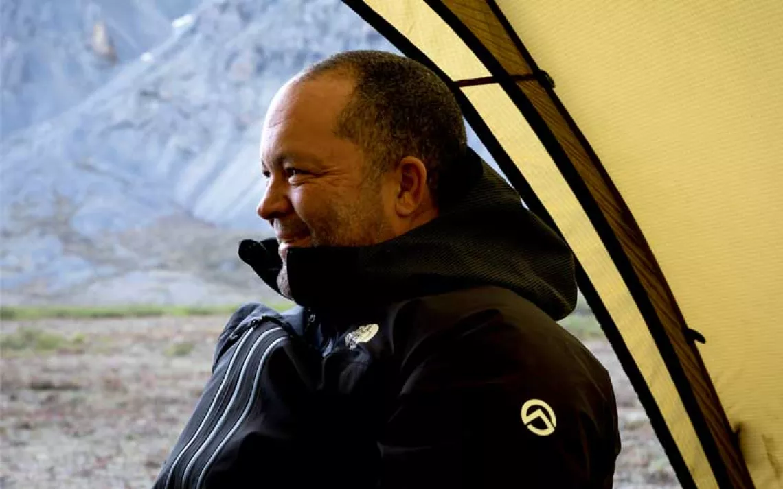 Profile of Ben Jealous sitting in a tent with the Arctic in the background.