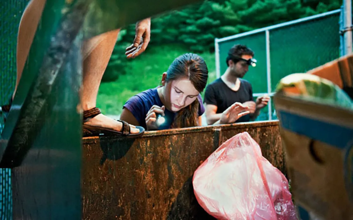 On a hot summer evening, Chupa, Natalya, and Majesty dive for vegetables in a supermarket dumpster.