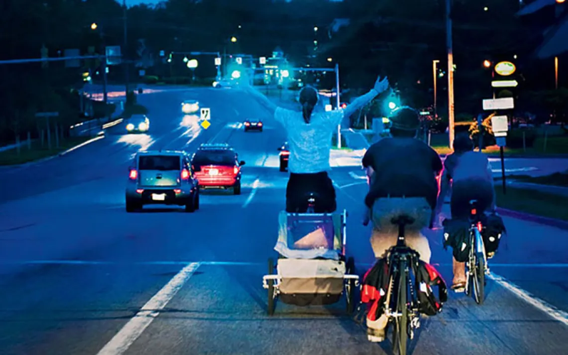 With his finds secured in a scavenged baby trailer, Chupa exults on the ride home. 'I was embracing the night,' he says.