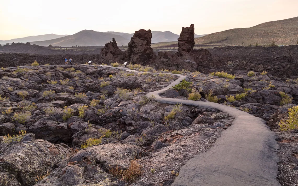 Hikers on North Crater Flow Trail at sunset.