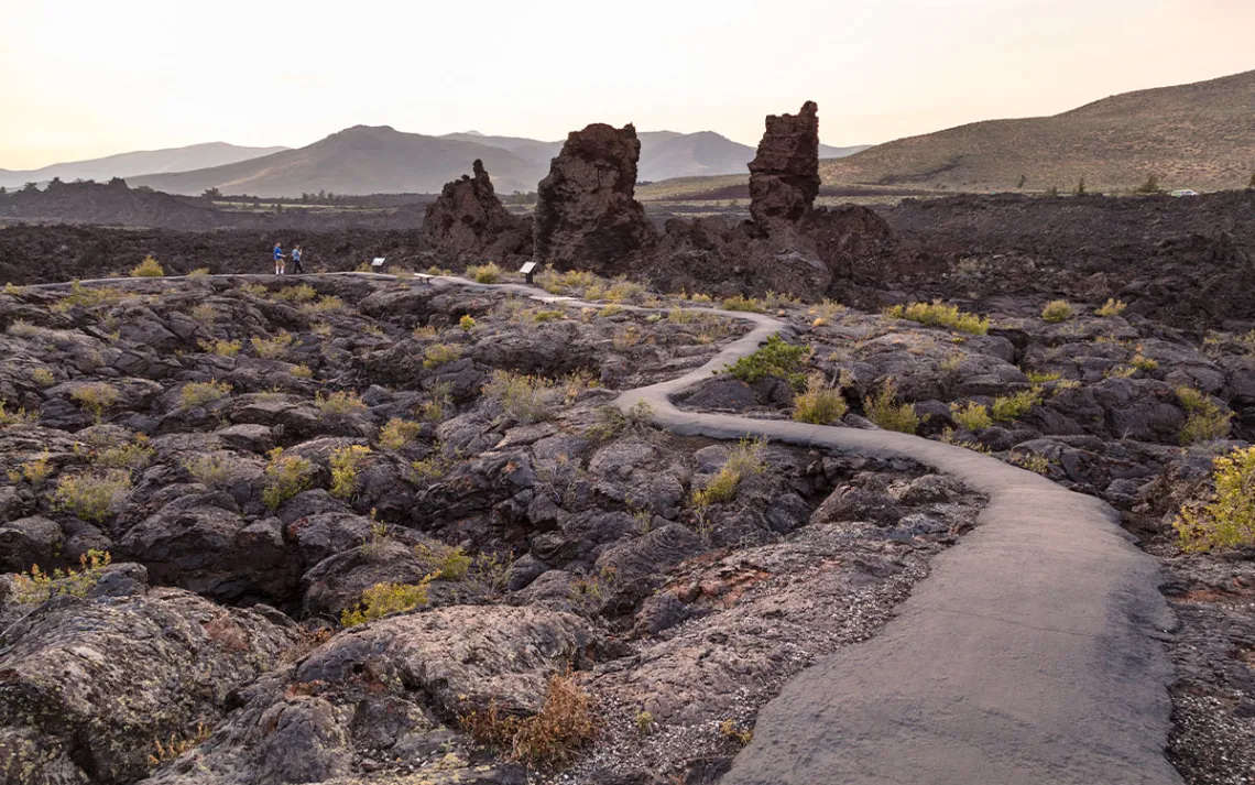 Hikers on North Crater Flow Trail at sunset.