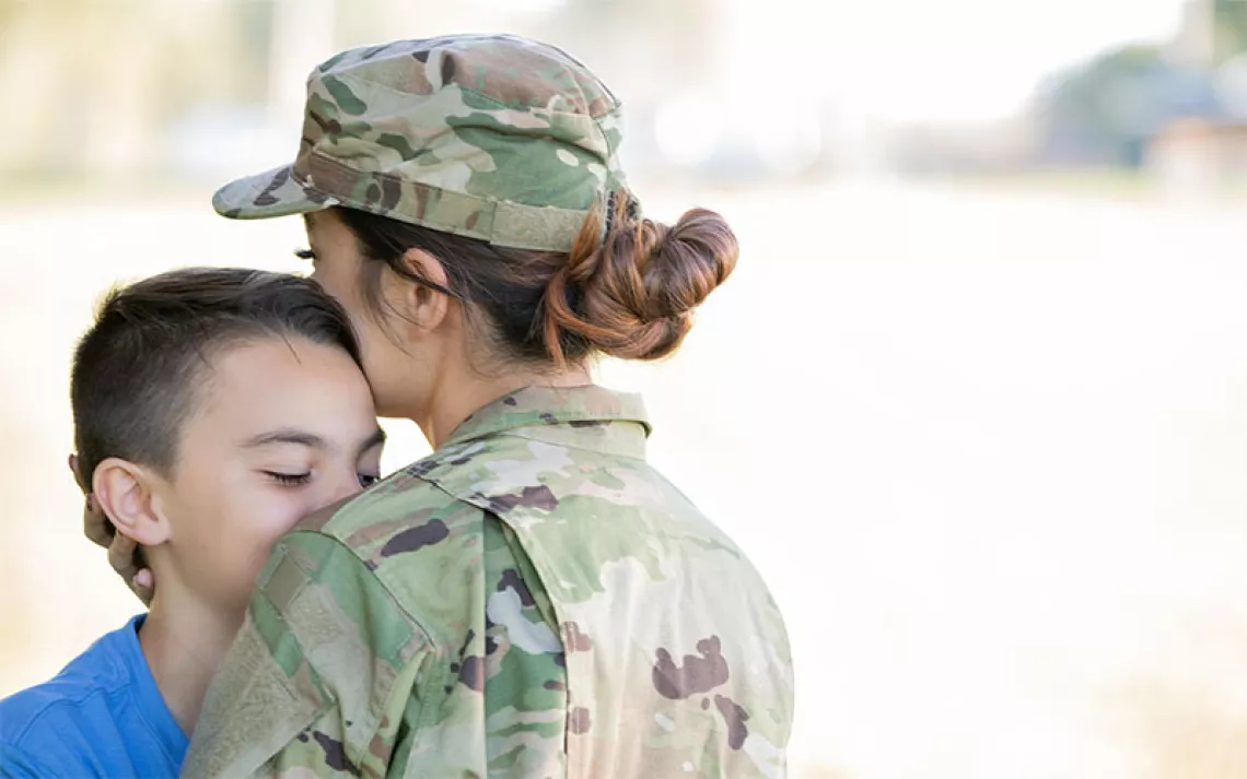 Active Duty Military Personnel kissing son goodbye
