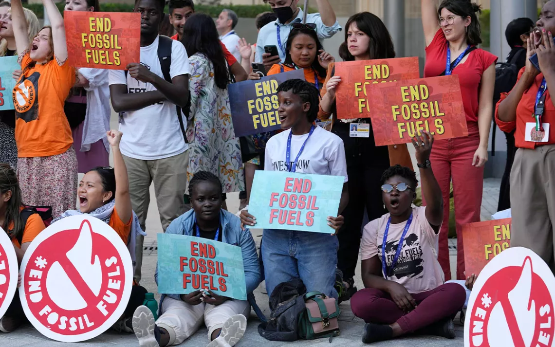 Vanessa Nakate, of Uganda, center, takes part in a protest against fossil fuels at the COP28 U.N. Climate Summit, Tuesday, Dec. 5, 2023, in Dubai, United Arab Emirates.