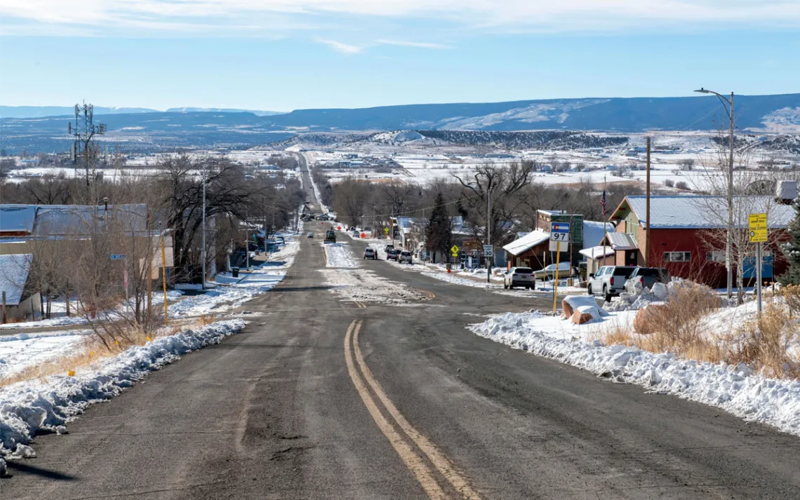  View looking down Main Street in Nucla, with several buildings and snow on the ground.