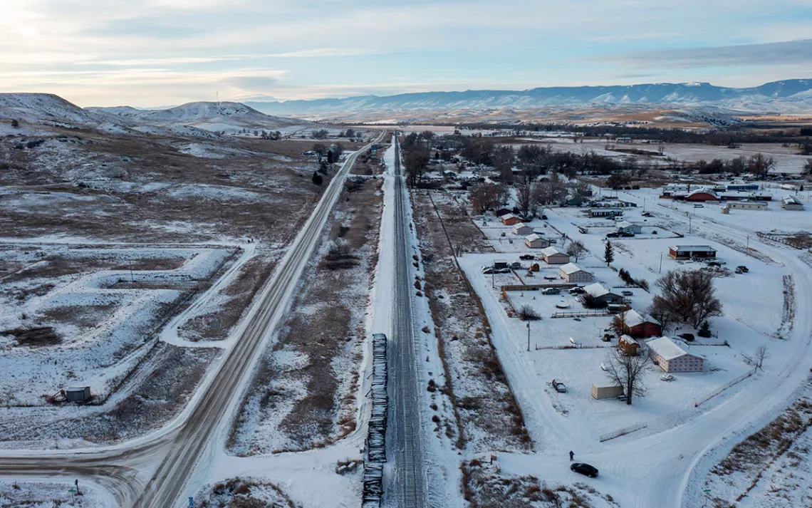 Aerial view of Wyola, showing a flat area covered with snow, with a few buildings and roads